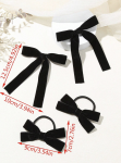 Set med två hårspännen och två hårsnoddar med svarta sammetsrosetter